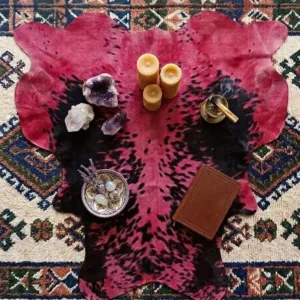 medium sized red cowhide area rug in bedroom beside queen bed