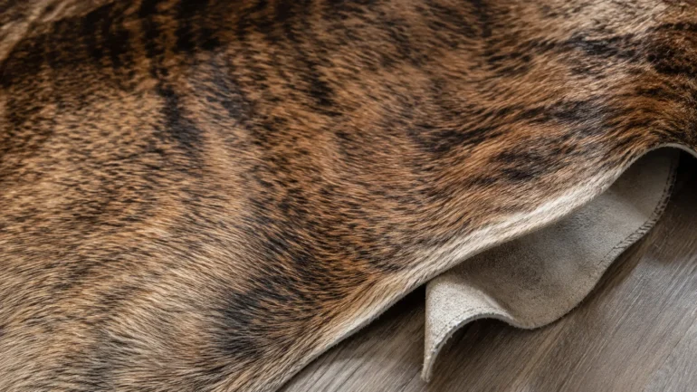 Genuine cowhide rug with natural hair and leather backing